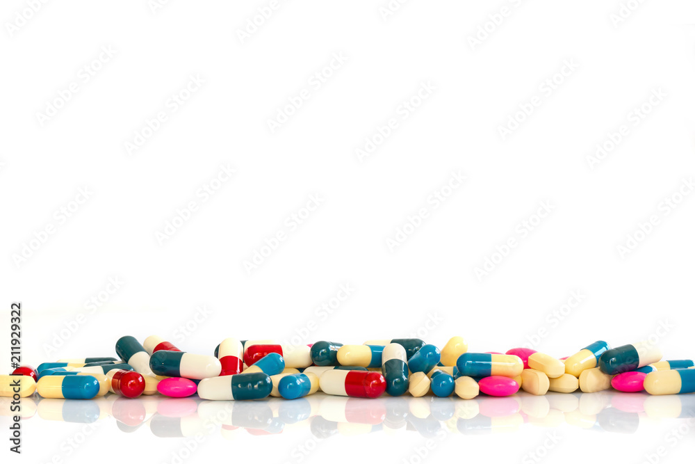 Line of colorful pills and medication on white background with copy space, health and medication concept Line of colorful pills and medication on white background with copy space, health and medication concept