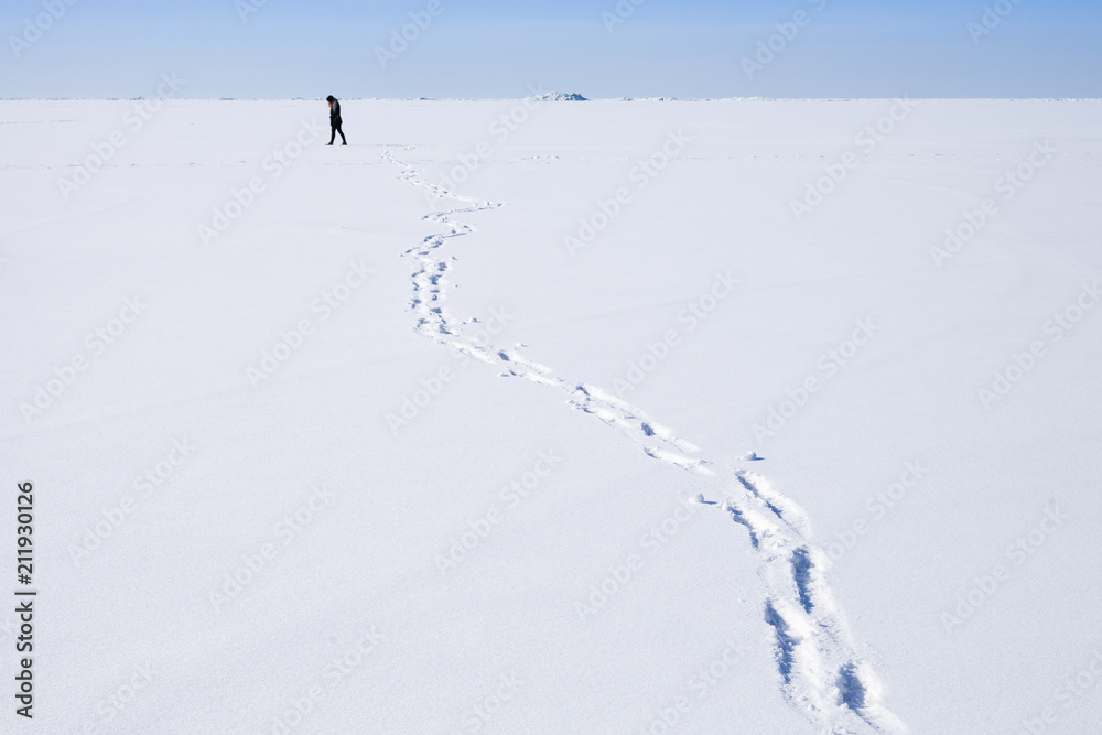 Footsteps of person walking on snowfield
