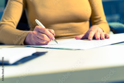 Businesswoman signing document