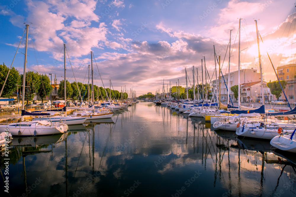 Rimini cityscape. Yachts in water channel in Rimini at the sunset. - obrazy, fototapety, plakaty 