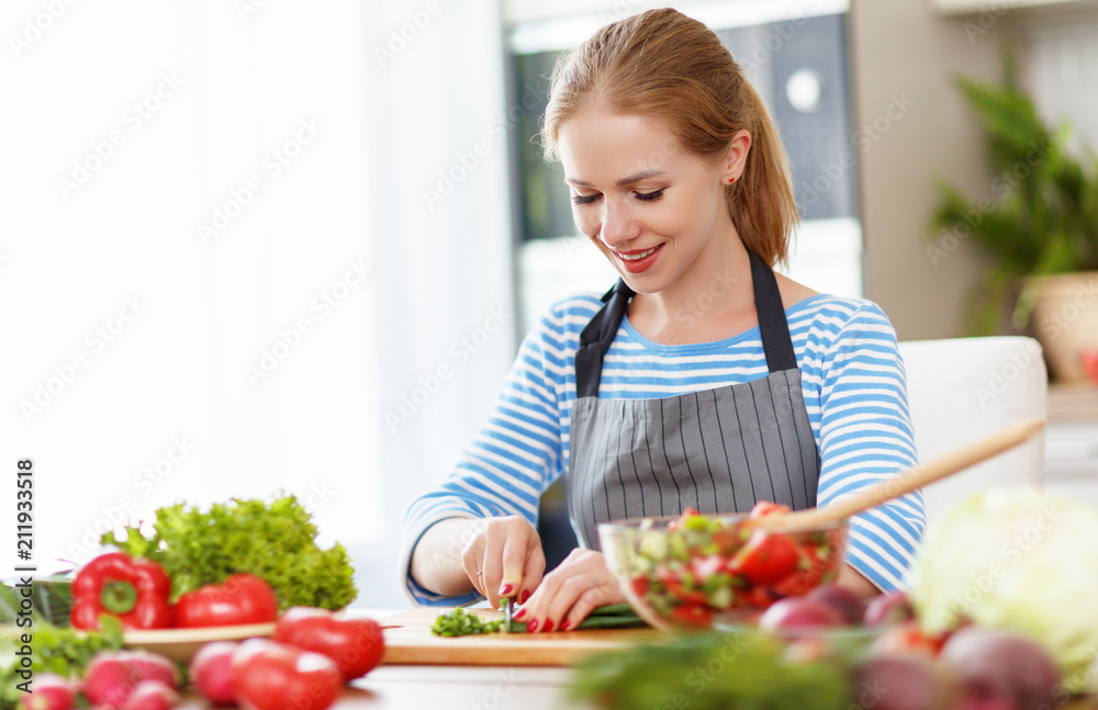 happy woman preparing vegetable salad in kitchen happy woman preparing vegetable salad in kitchen