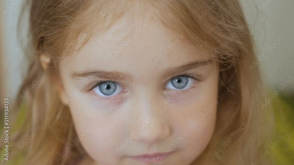 Portrait little young girl with blue eyes looking at camera Portrait little young girl with blue eyes looking at camera