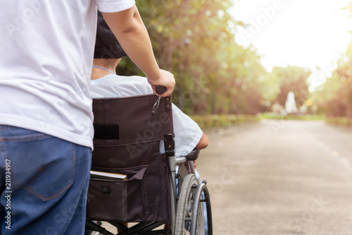 Caretaker with patient in wheelchair © bignai