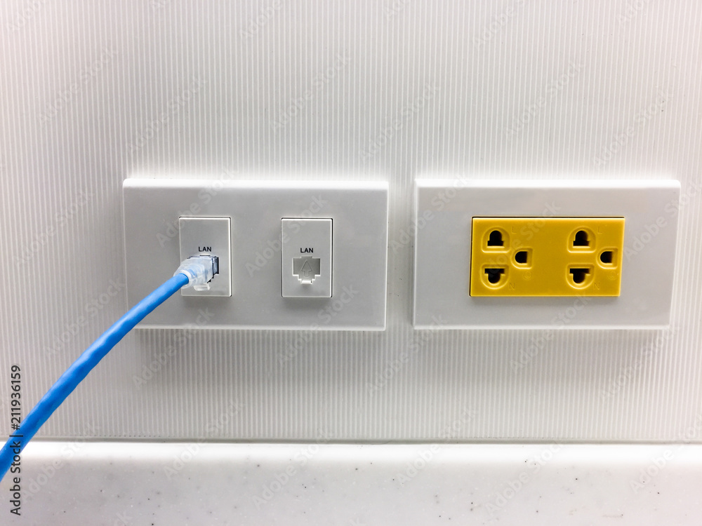 Insert ethernet cable into WiFi extender device in electrical socket Stock  Photo | Adobe Stock