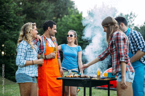 Happy friends enjoying barbecue party © NDABCREATIVITY
