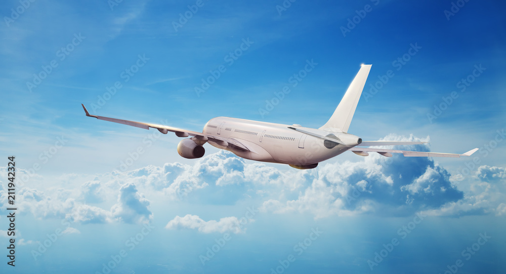Obraz premium Commercial airplane jetliner flying above clouds