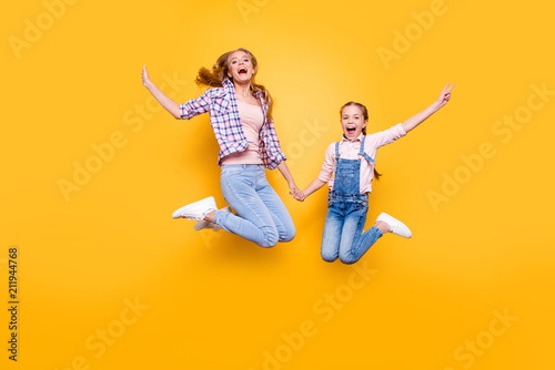Mom mum mommy maternity two people best friendship upbringing rejoicing concept. Full length size portrait of cheerful joyful stylish modern relatives jumping up in air isolated on bright background