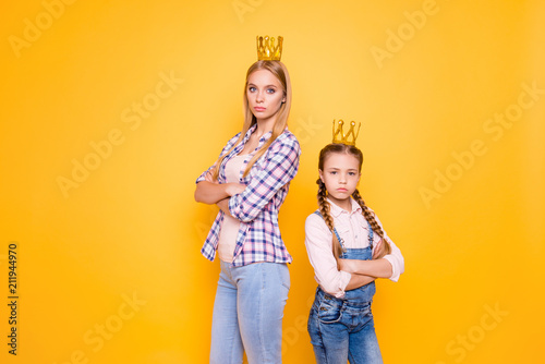 Older vs younger siblings! Who is parents best favorite blue-eyed girl?Bad behavior denim jeans outfit concept. Portrait of confident narcissistic beautiful girls isolated on bright background