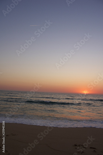 This image shows a sunset at the beach © Dani.Mateus Creative