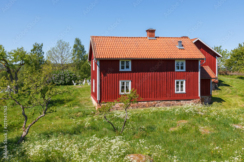 Old farmhouse with garden in a summer landscape Old farmhouse with garden in a summer landscape