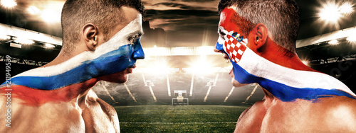 Soccer or football fan with bodyart on face on stadium - flags of Russia vs Croatia. Sport Concept with copyspace.