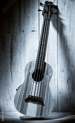 ukulele bass on wooden background © MIGUEL GARCIA SAAVED