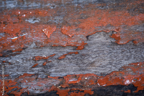 Old wooden plank with red colour painted coating worn out texture