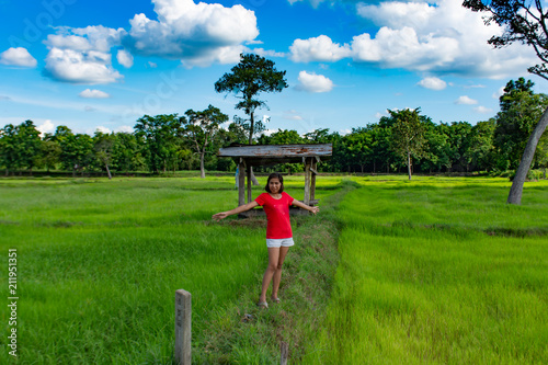 Woman in rice fields. And the beautiful green trees.