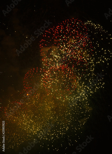 Foto Colored sparks of flying particles on a dark background.