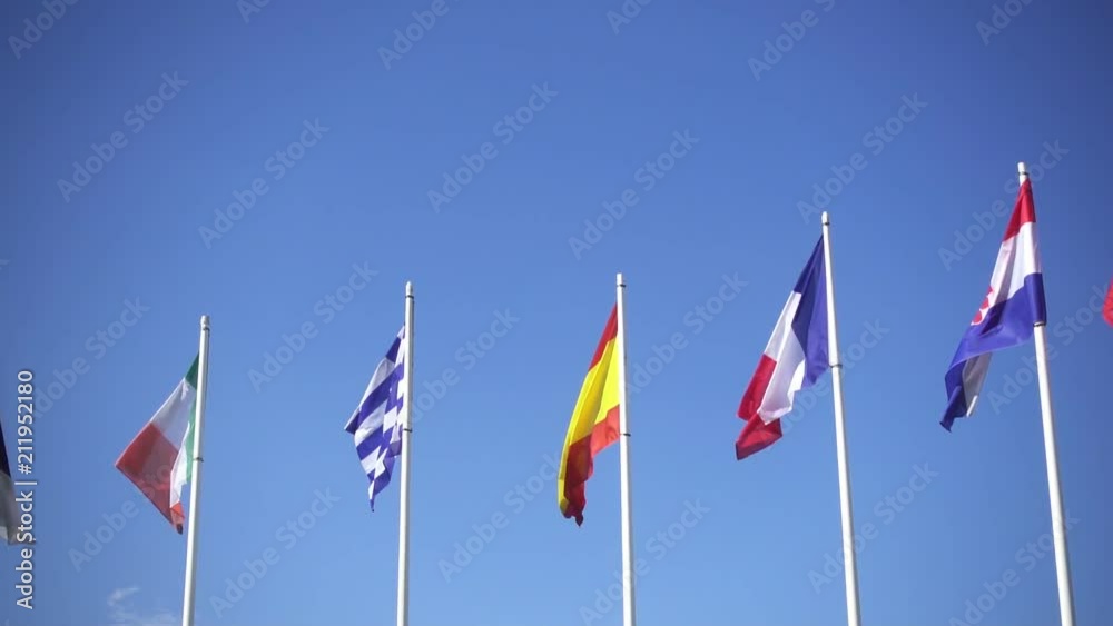 Flags of European countries of Ireland, Spain, Greece, Fance and Croatia against the blue sky. Smooth slowmotion from a 120 fps original shoot