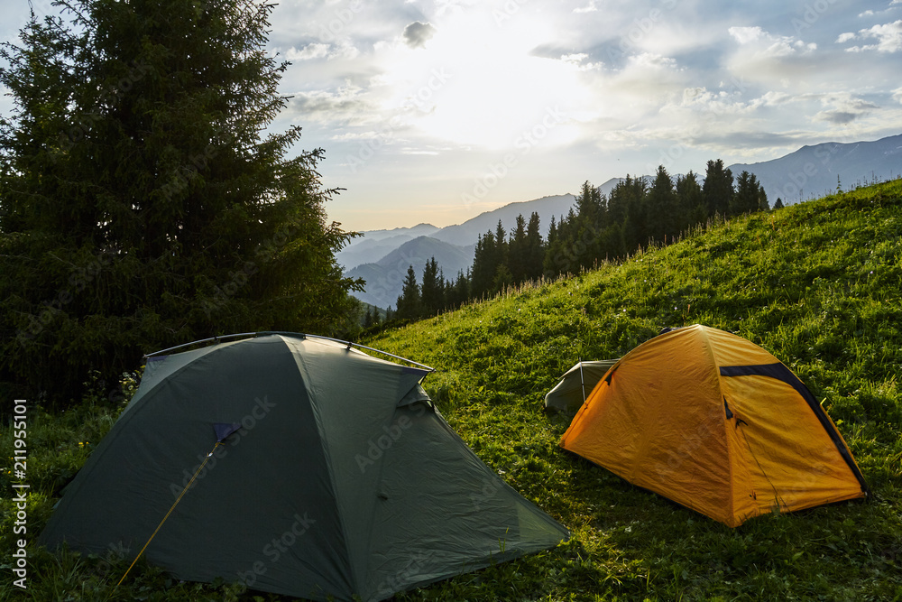 Camping in mountain landscape during sunrise. Summer landscape in the Kok Zhailau near the city of Almaty, Kazakhstan, central Asia