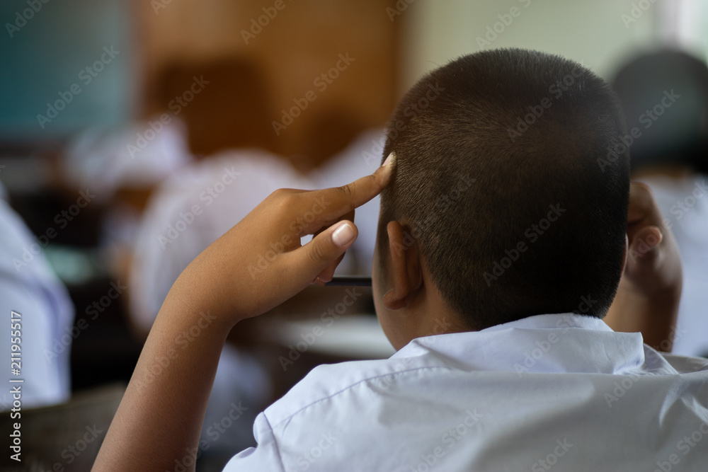 Students thinking and taking exam with stress in school classroom. Students thinking and taking exam with stress in school classroom.