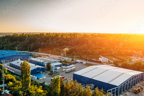 Aerial view of warehouse storages or industrial factory or logistics center from above. Aerial view of industrial buildings and equipment machines