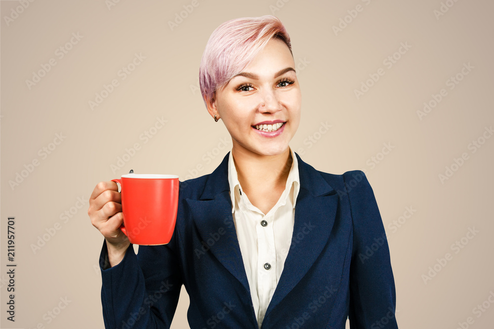 Young business woman holds cup of coffee and smiles, isolated on light pink background Young business woman holds cup of coffee and smiles, isolated on light pink background