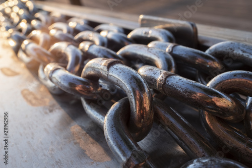 Long Metal Chains On A Boat Dock Near The Water photo