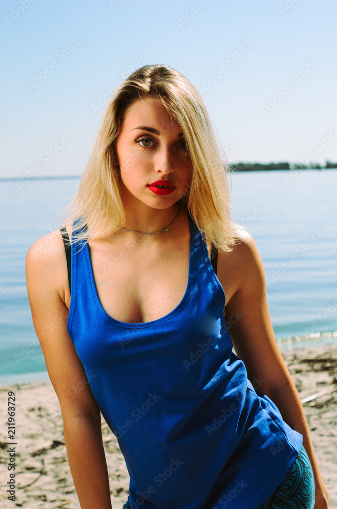 the athlete on the beach posing. blonde girl with big eyes posing