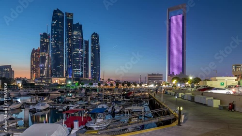 Al Bateen marina Abu Dhabi day to night timelapse with modern skyscrapers on background photo