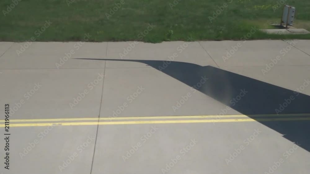 Shadow of wing - aircraft taxiing to runway for takeoff Shadow of wing - aircraft taxiing to runway for takeoff