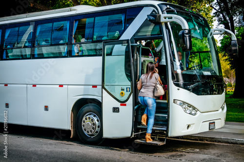 Photo transport, tourism, road trip and people concept - passenger boarding to travel