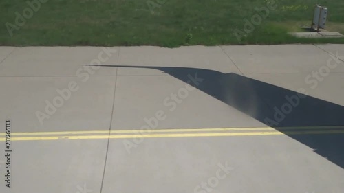 Shadow of wing - aircraft taxiing to runway for takeoff