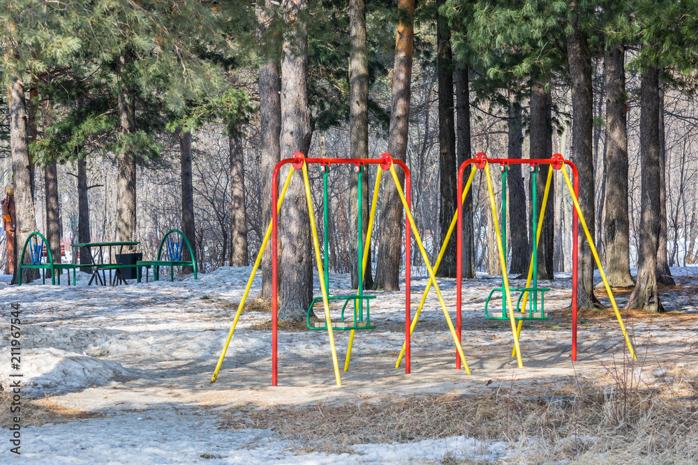 Beautiful swing for skating on playground in spring park. Beautiful swing for skating on playground in spring park.