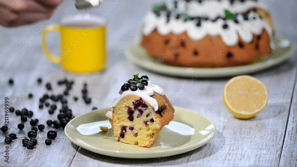 Delicate delicious cake with black currant. Eating a piece of cake with black currant. Delicate delicious cake with black currant. Eating a piece of cake with black currant.
