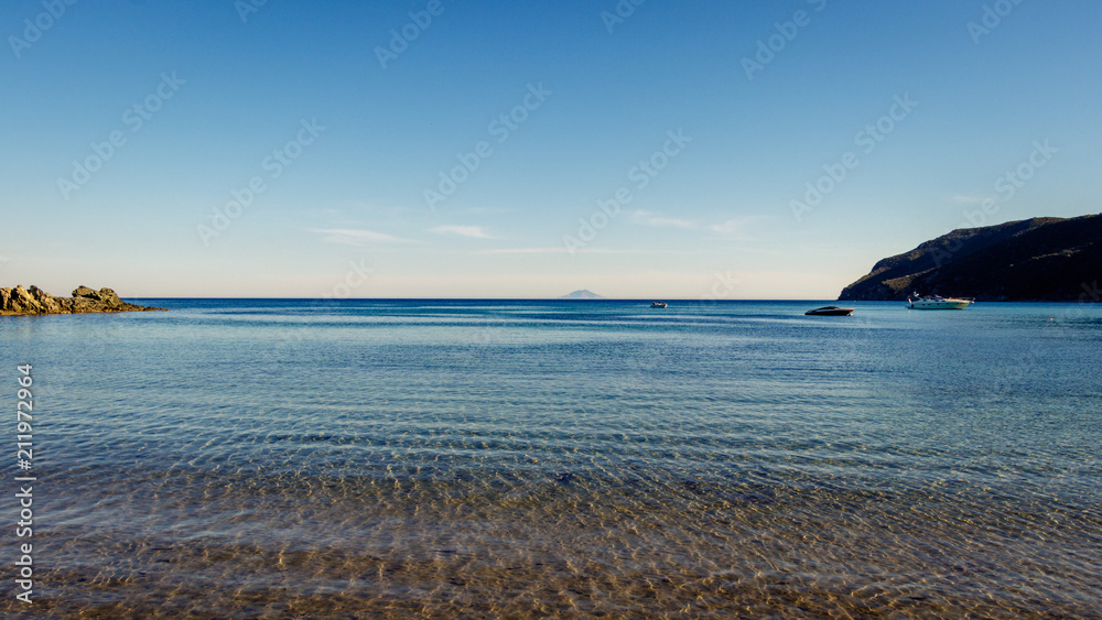 Looking at the island of Montecristo in Italy from the Laconella Beach on the Elba island. Taken on a beautiful tranquil morning in the spring.