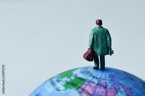miniature traveler man on the terrestrial globe