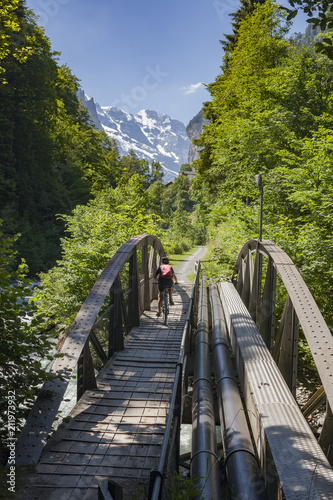 senior woman, riding her e-mountainbike in the Lauterbrunnen valley, Jungfrauregion,Berner Oberland,Switzerland