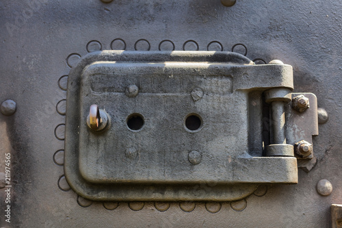 Small watch door on the front of an old stream engine in Csernat, Romania photo