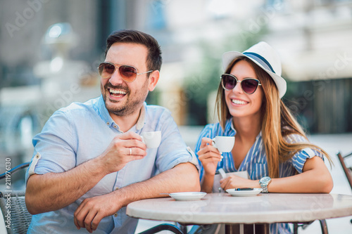 Beautiful loving couple sitting in a cafe enjoying in coffee and conversation