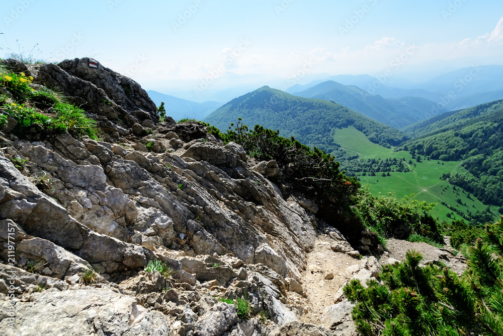 The rocky slope with view on cross paths. Day foto