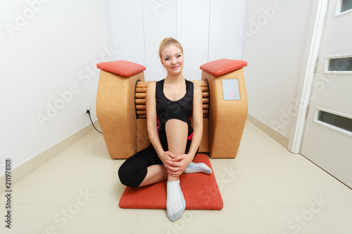 Woman relaxing after cellulite treatment on machine