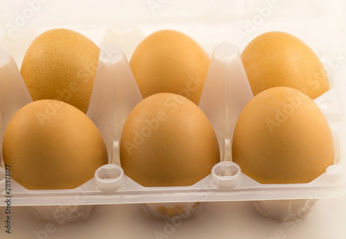 Yellow eggs in a plastic tray photo