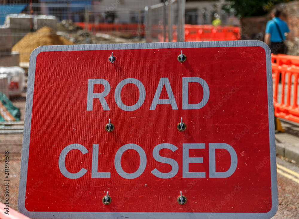Large sign in the middle of a work on the street, indicating closed street
