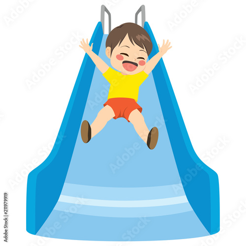 Cute little child boy playing on blue slide at playground