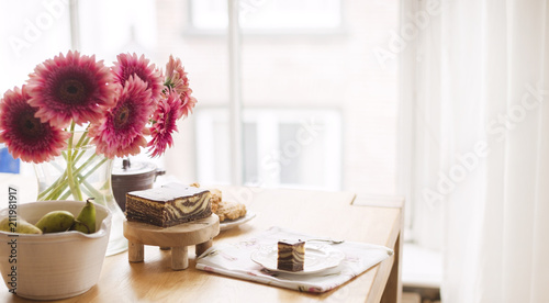 Breakfast on the table by the window. A bouquet of flowers and coffee. Good morning. Copy space.