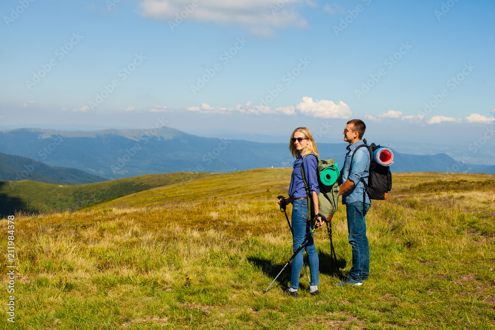 Happy couple with walking poles