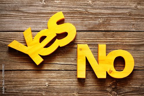 Wood yellow words yes and no on a wooden texture background photo