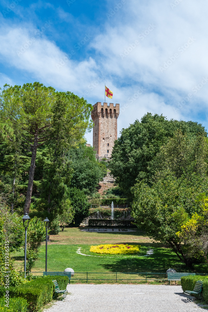 The tower of Este castle with flag and a fountain in the park in the ancient city of Este, Padua, Italy