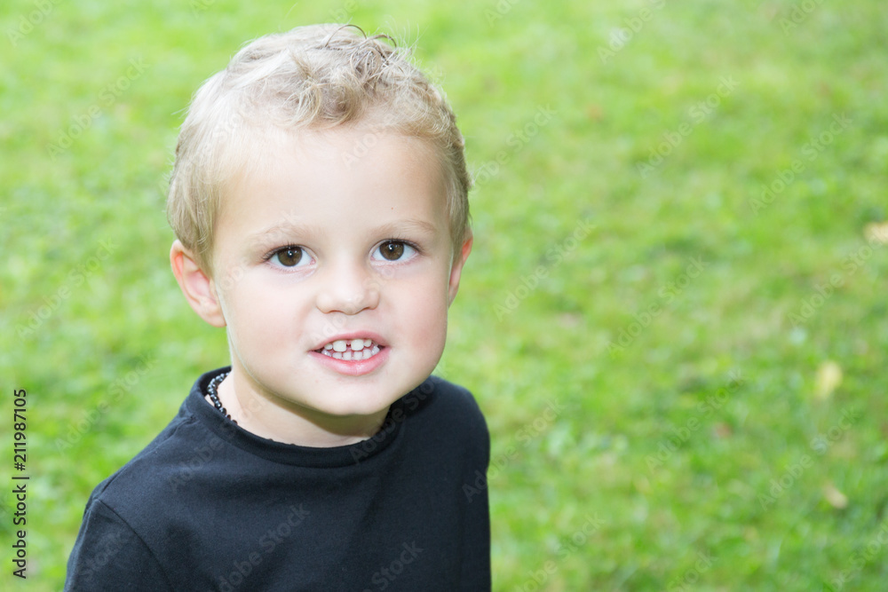 cheerful child blond boy in green grass outdoor cheerful child blond boy in green grass outdoor