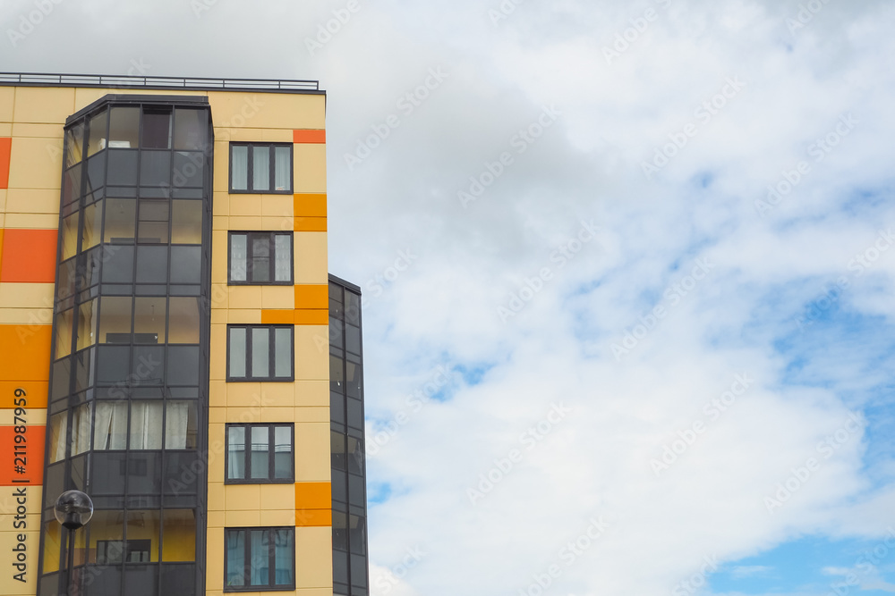 Modern beautiful new buildings. Colored wall on the background of blue sky. Modern beautiful new buildings. Colored wall on the background of blue sky.