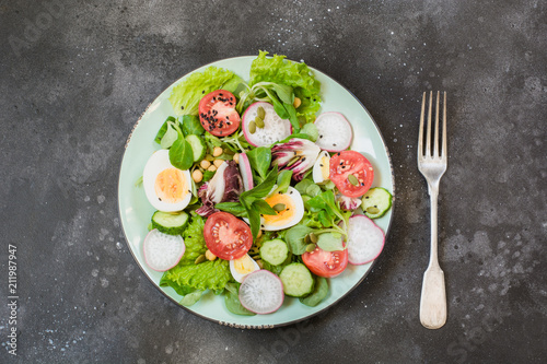 Fresh salad with vegetables and eggs for proper nutrition. Summer food. Top view, copy space.