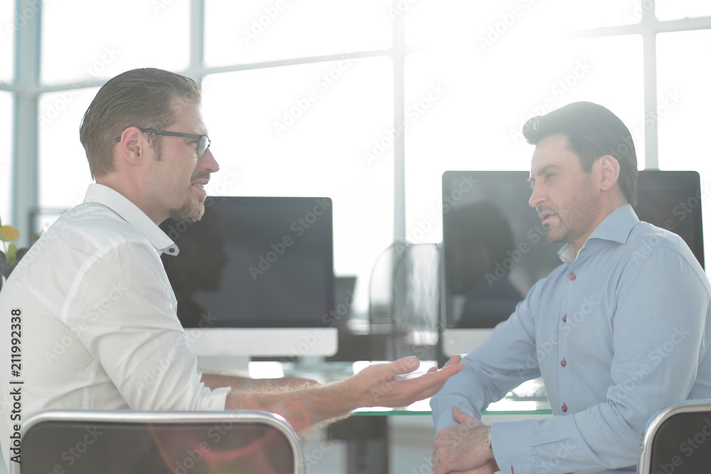 rear view.two employees discussing new ideas. rear view.two employees discussing new ideas.